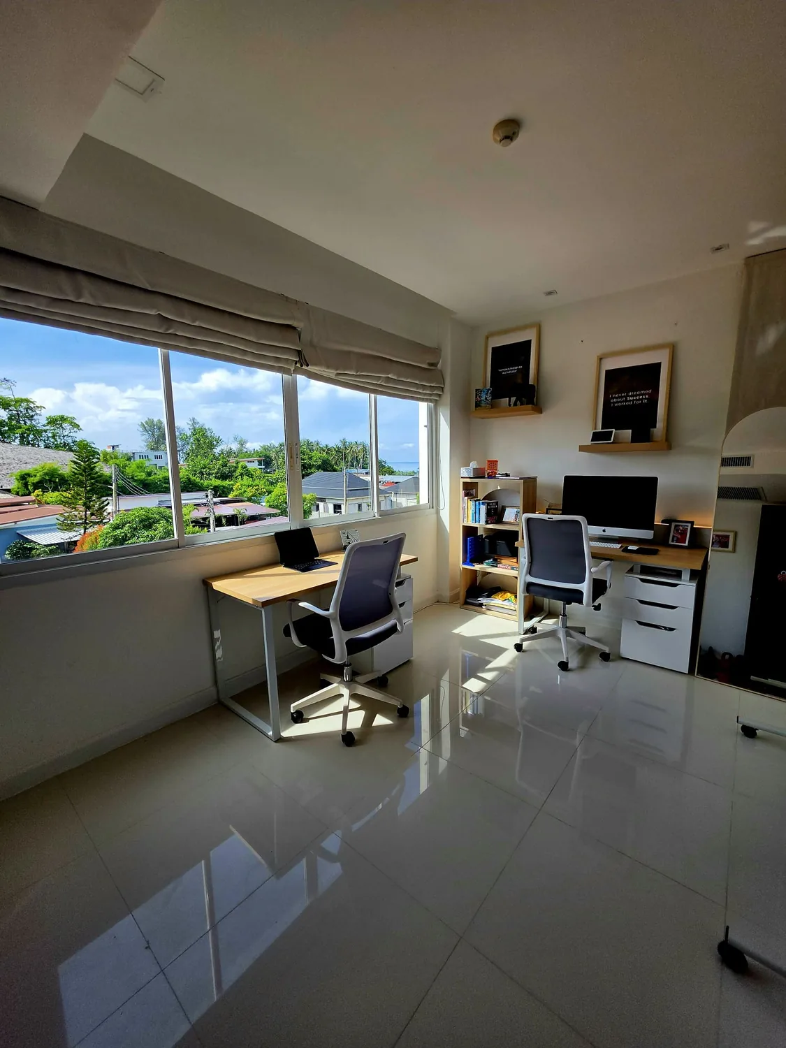 Bright home office with a glimpse of the sea through its windows